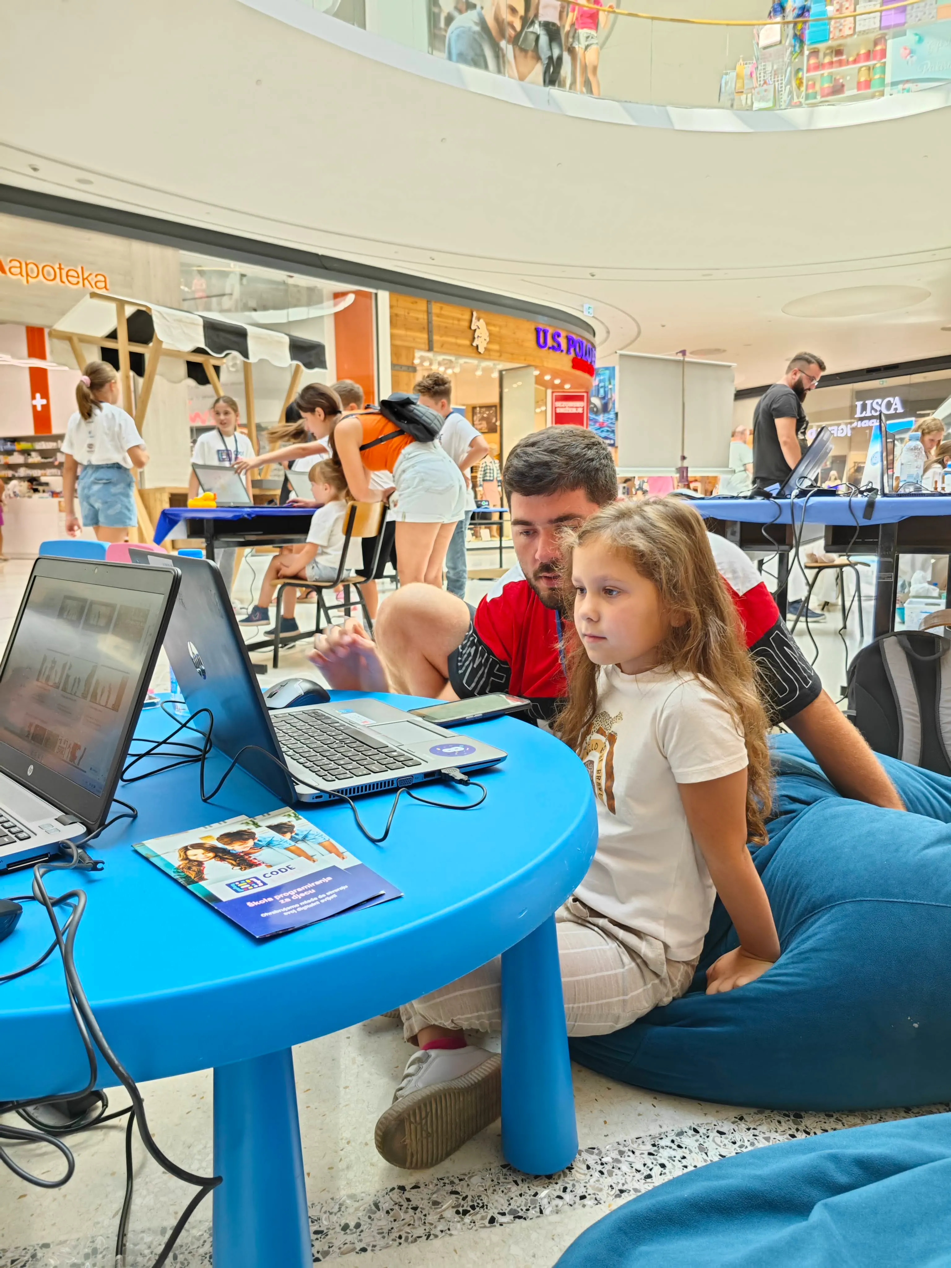 Child writing on board with teacher